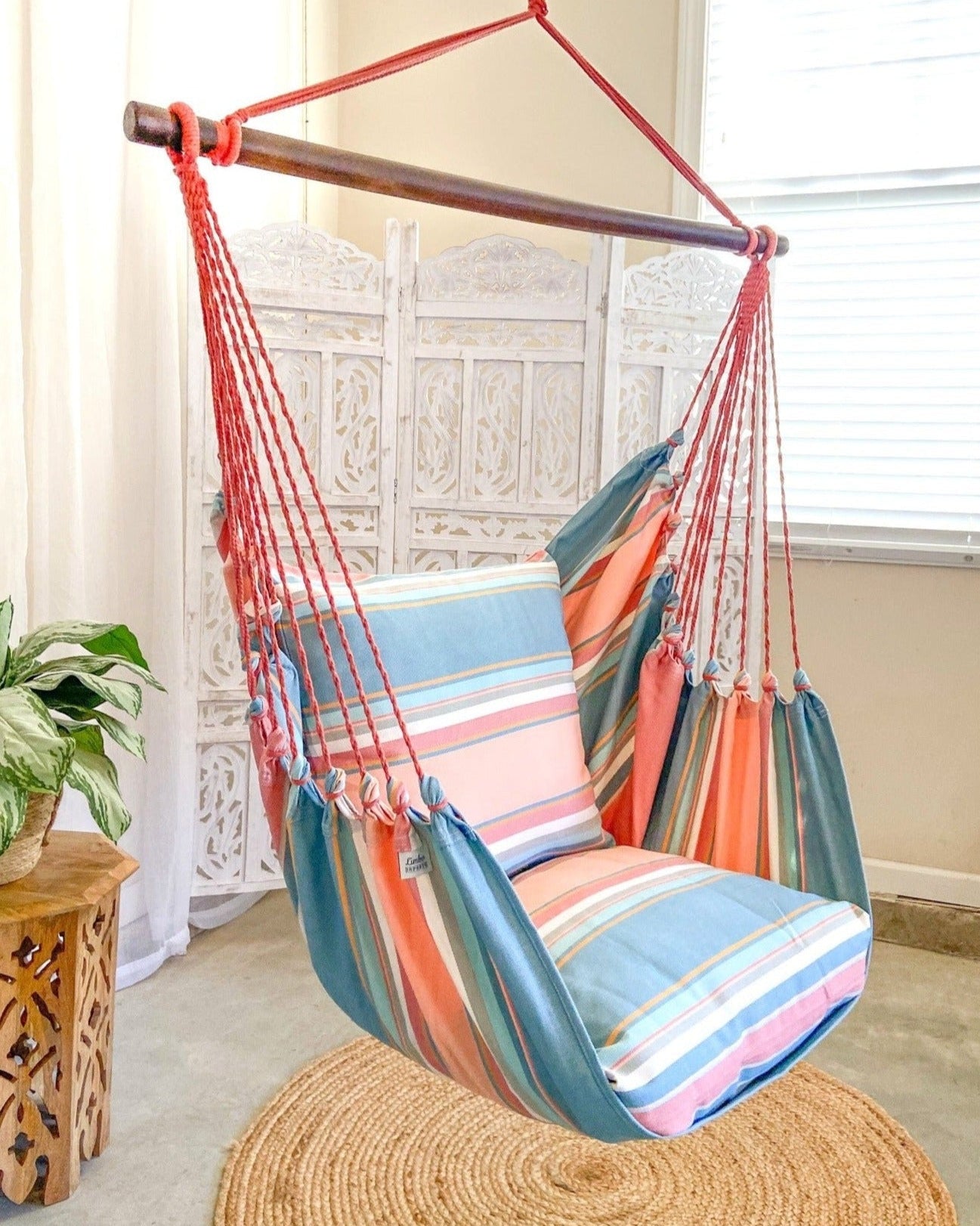 striped pink and light blue hammock chair indoors