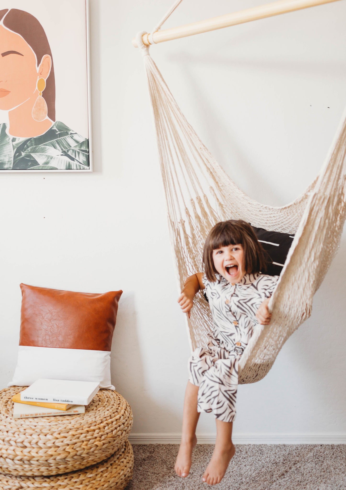 little girl in a white cotton hammock chair