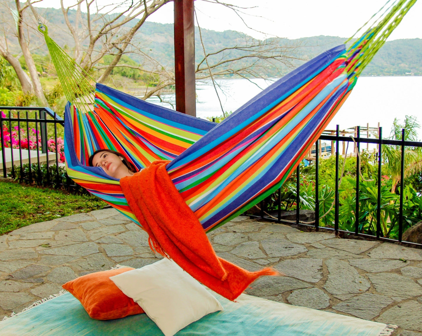 rainbow multi color hammock on a backyard