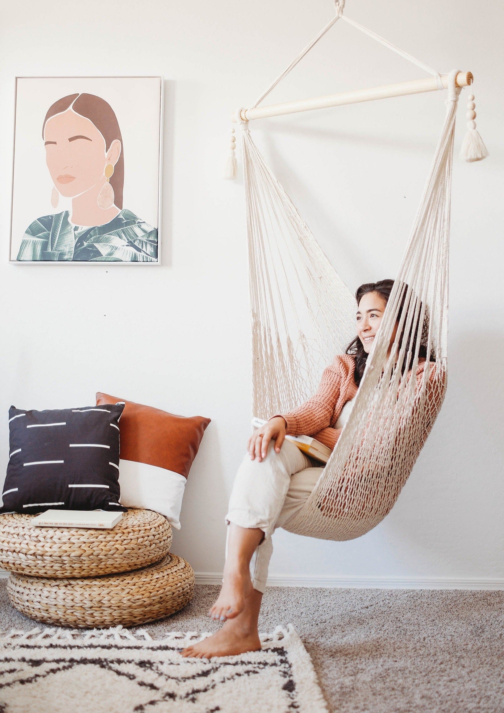 woman sitting on a woven macrame hanging chair
