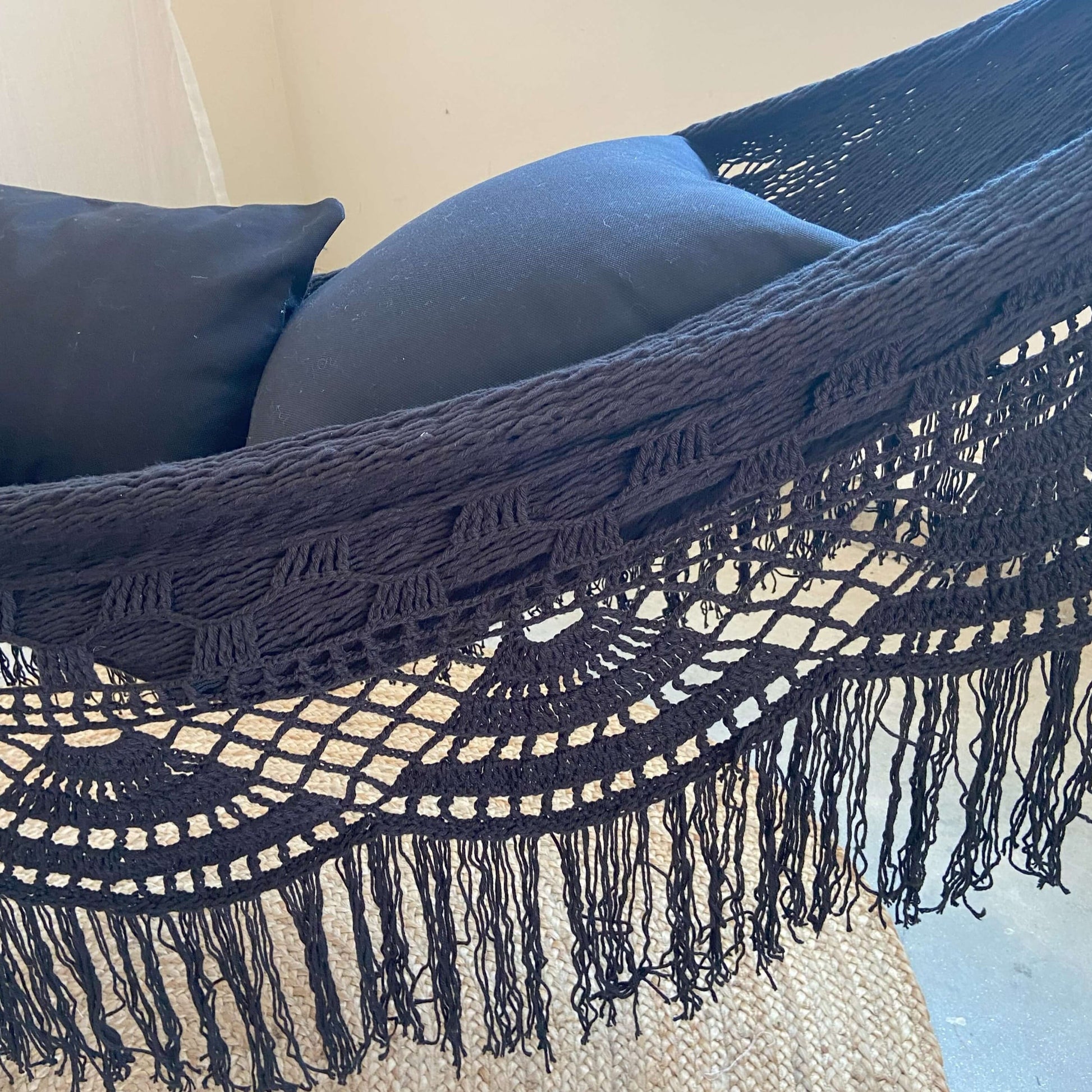 Closeup Black Woven Crochet Hammock with two black pillows