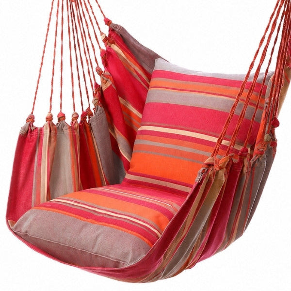 A  vibrant red pink orange striped fabric hanging hammock chair with a wooden support bar and two matching striped cushions, shown on a white background