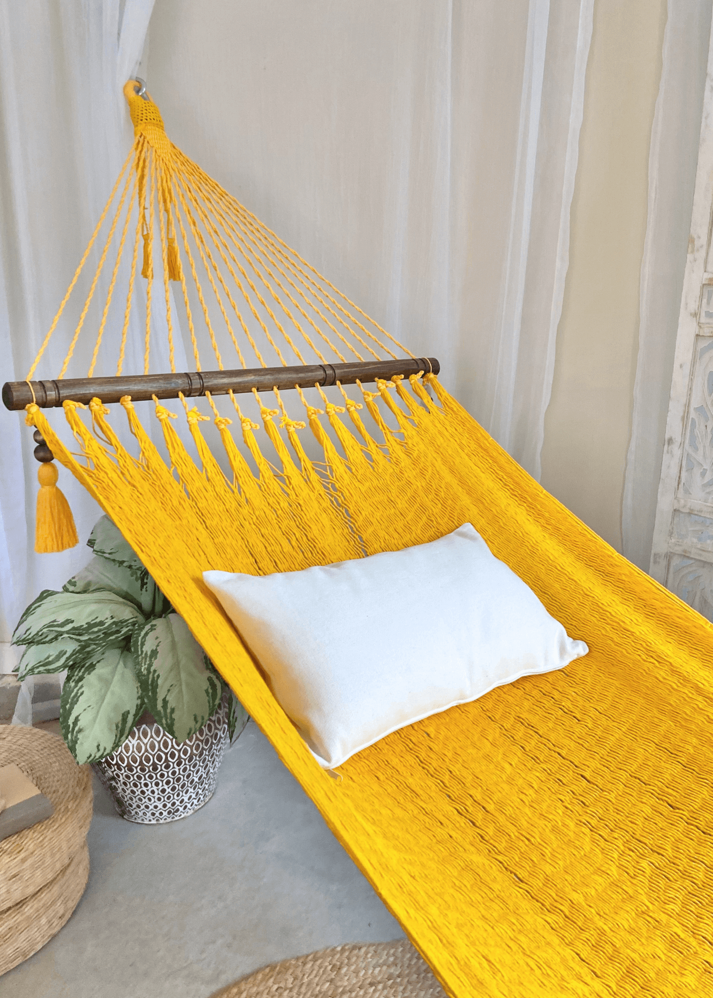 yellow hammock with white pillow