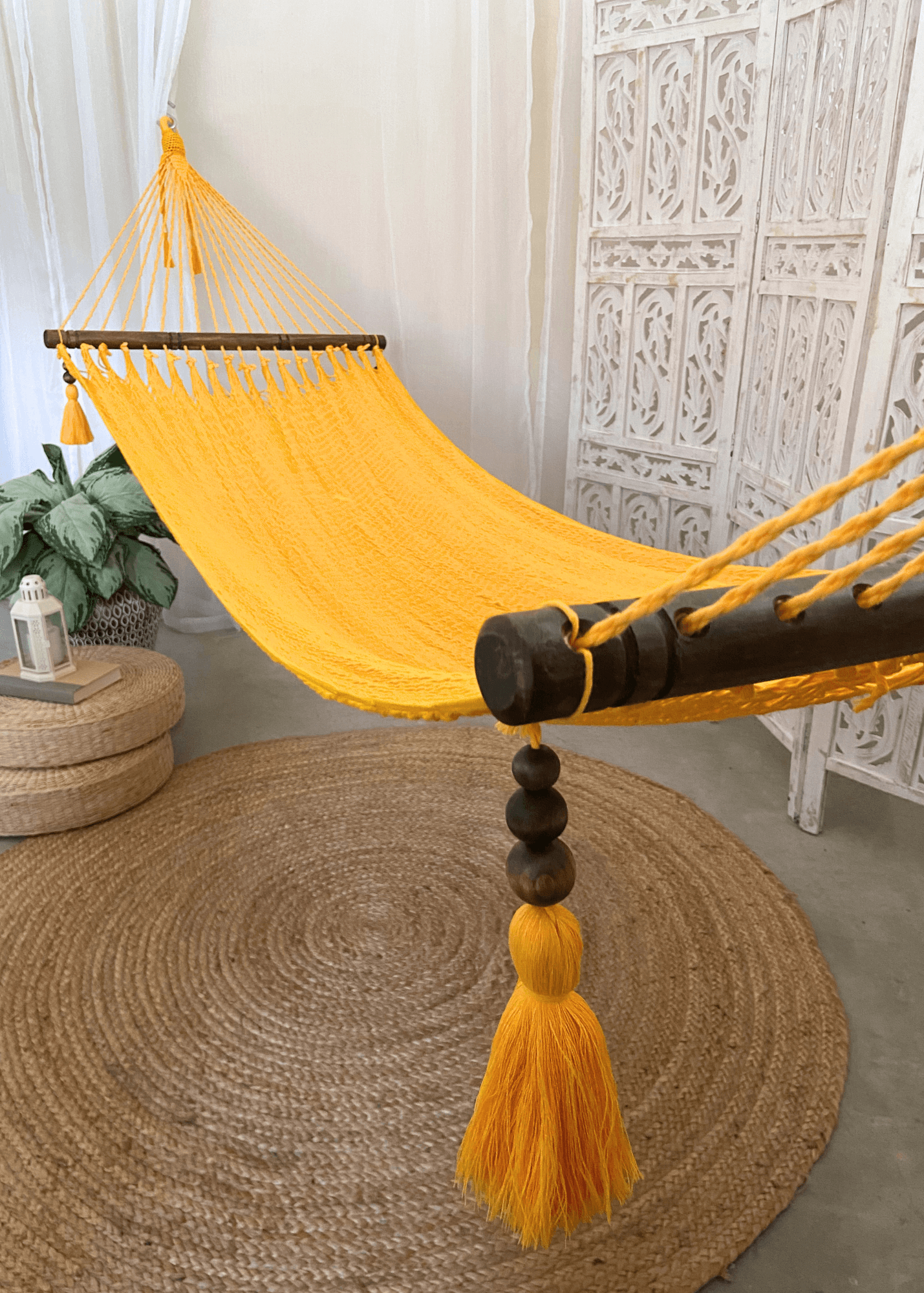 yellow hammock handwoven with hanging wood beads