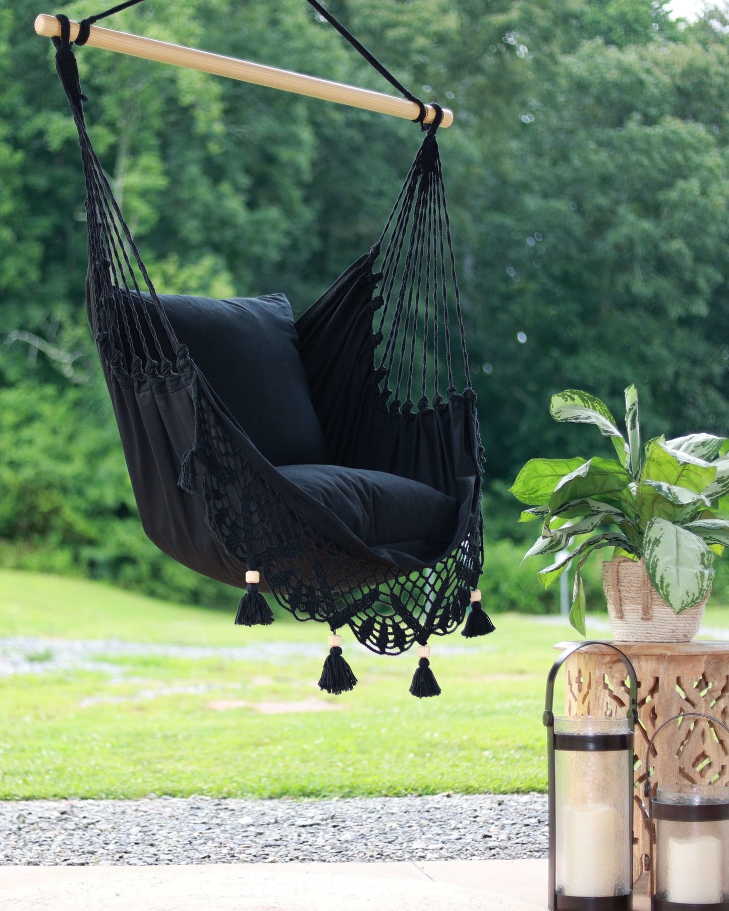 black macrame hammock swing chair on a backyard