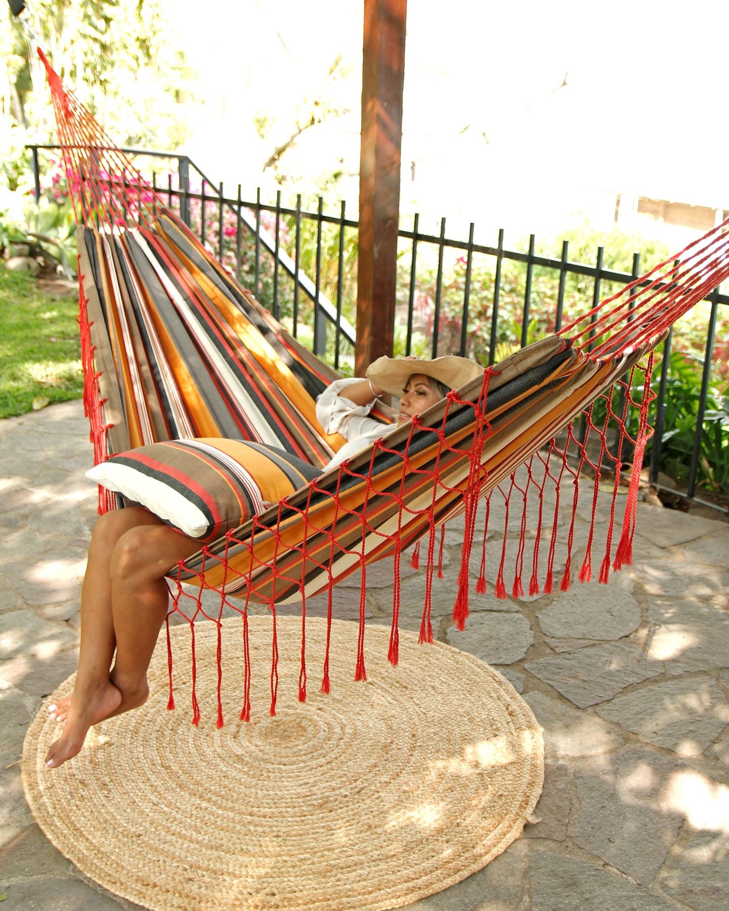 woman sitting on a canvas hammock