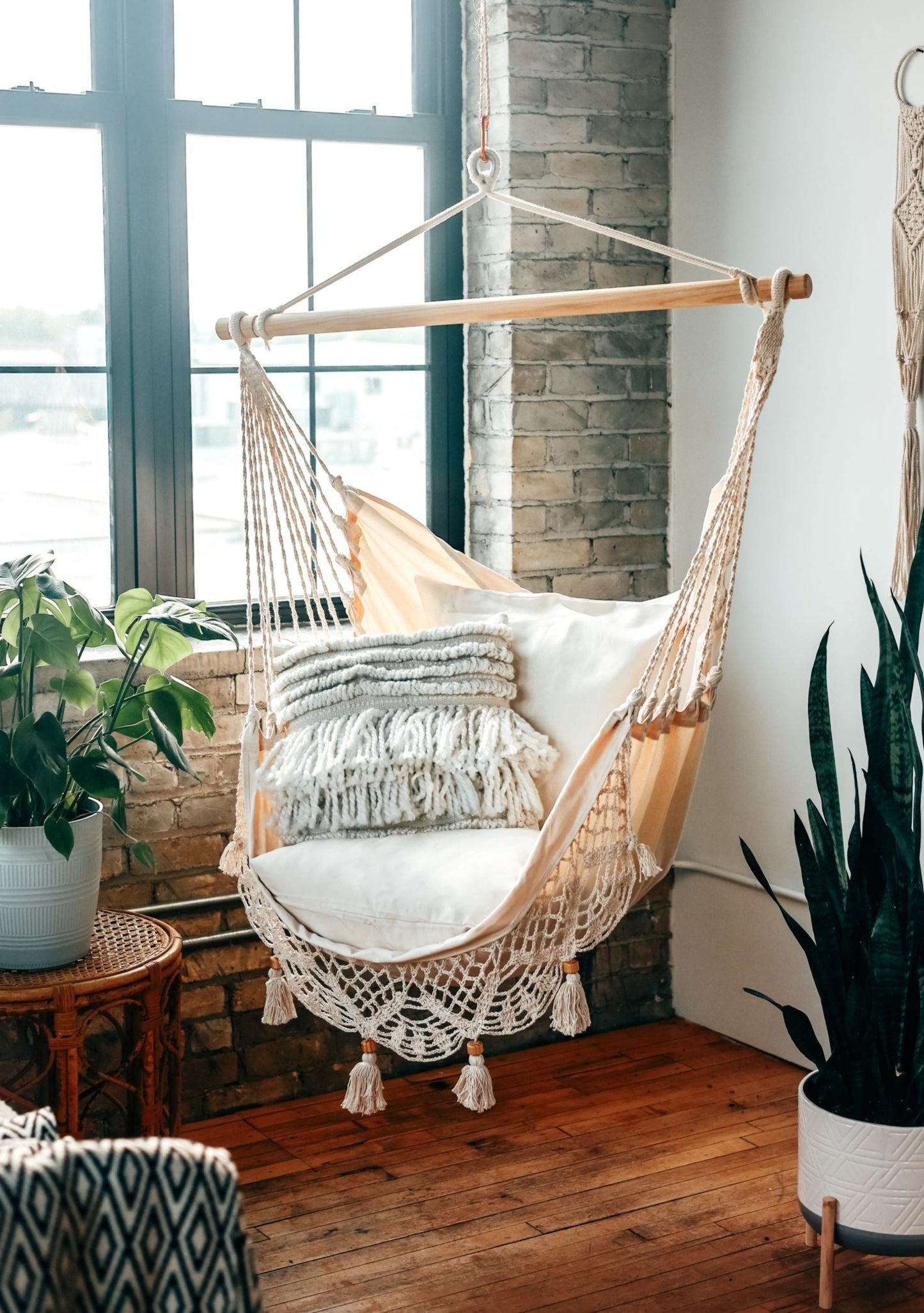 indoor crochet hammock swing chair in an apartment with brick walls