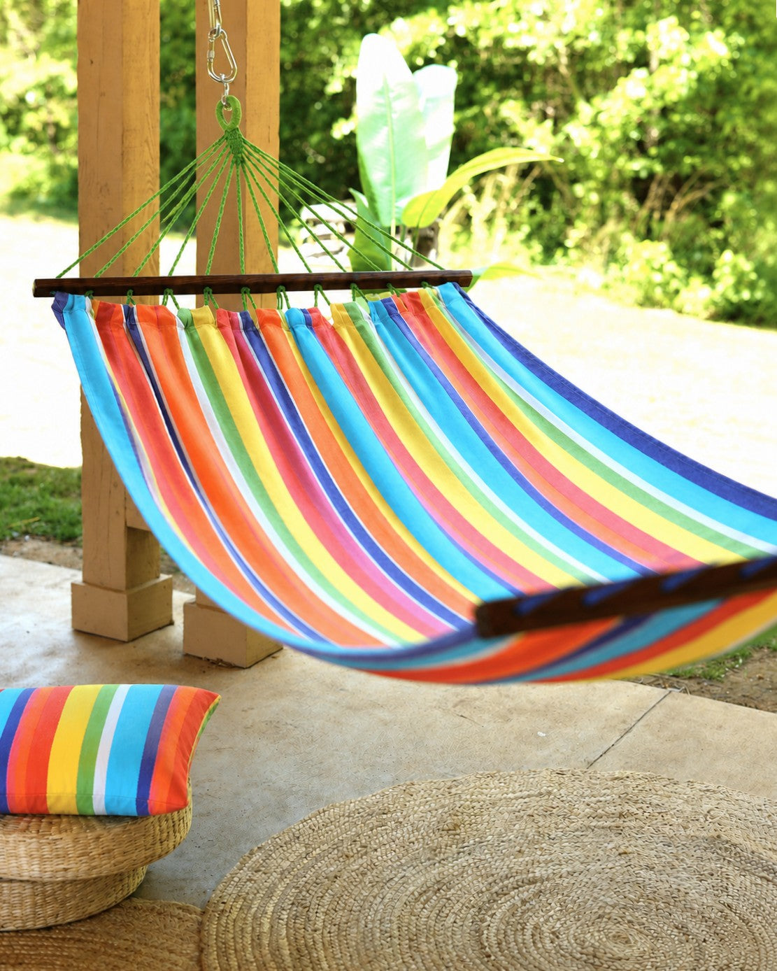 colorful hammock with spreader bars on a porch