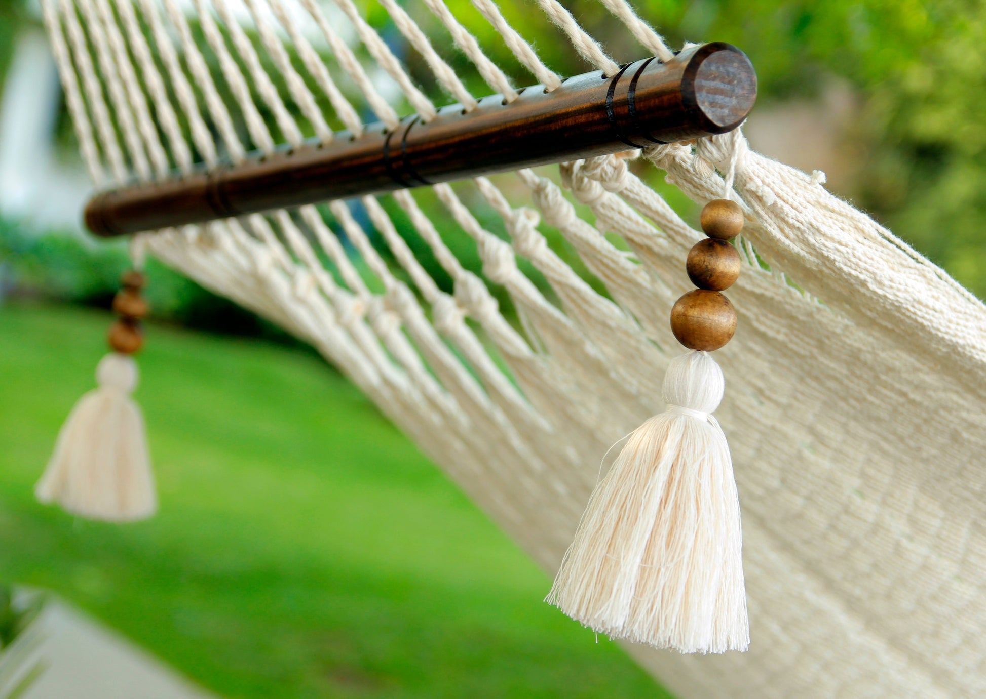woven white hammock with tassel beads