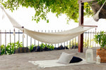 woven white hammock with spreader bars