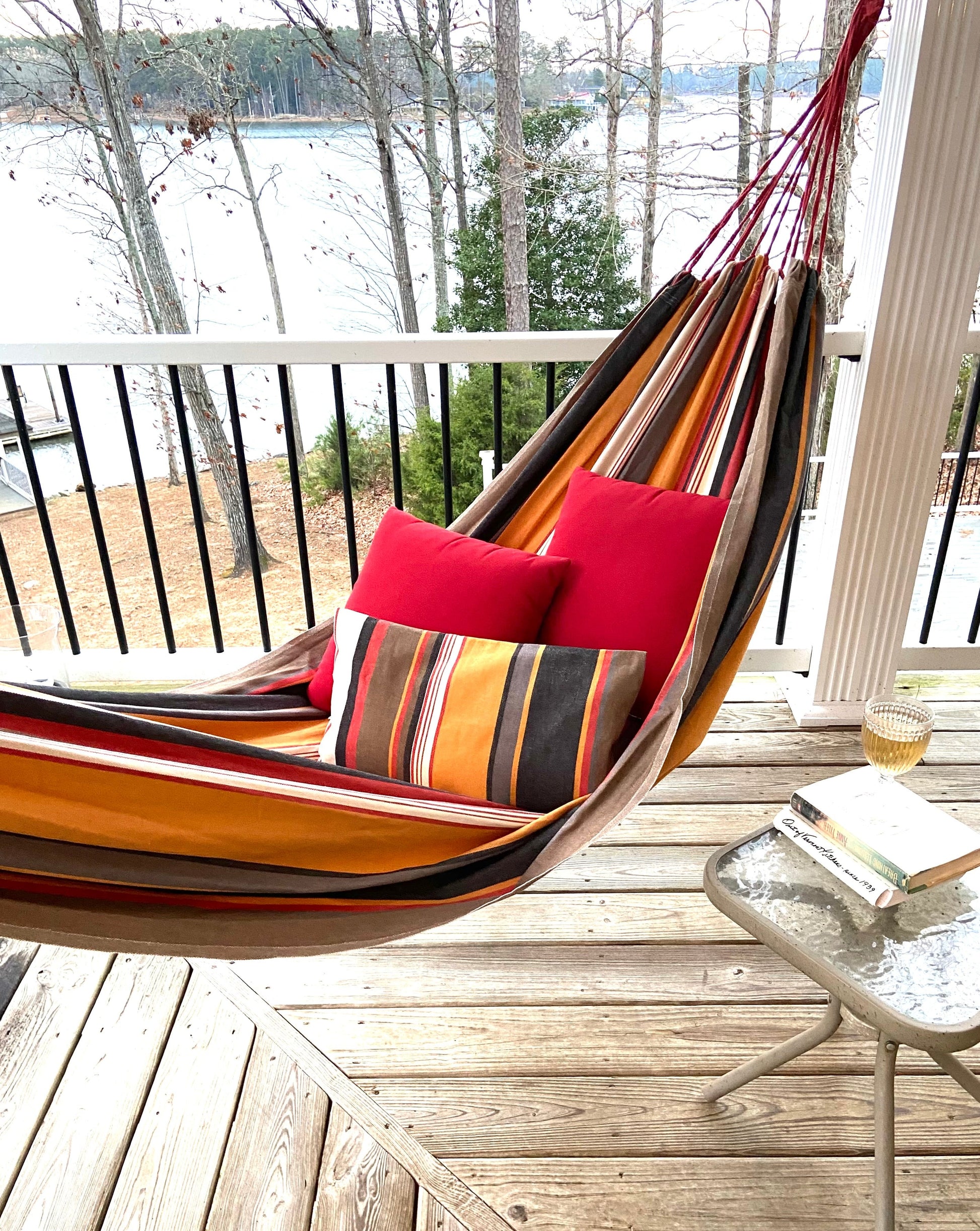 canvas hammock on a deck with red pillow