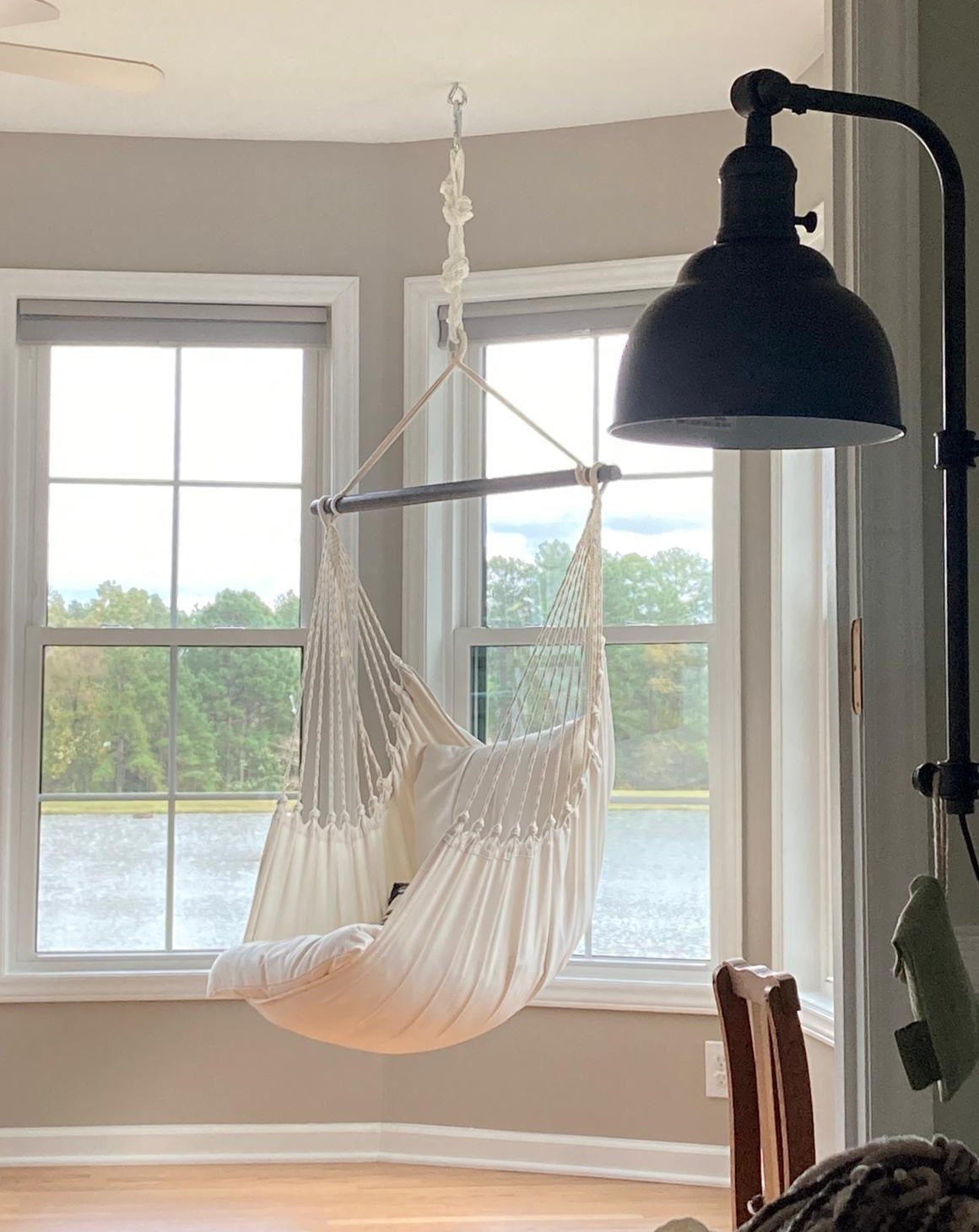 White Hanging hammock chair swing next to a window