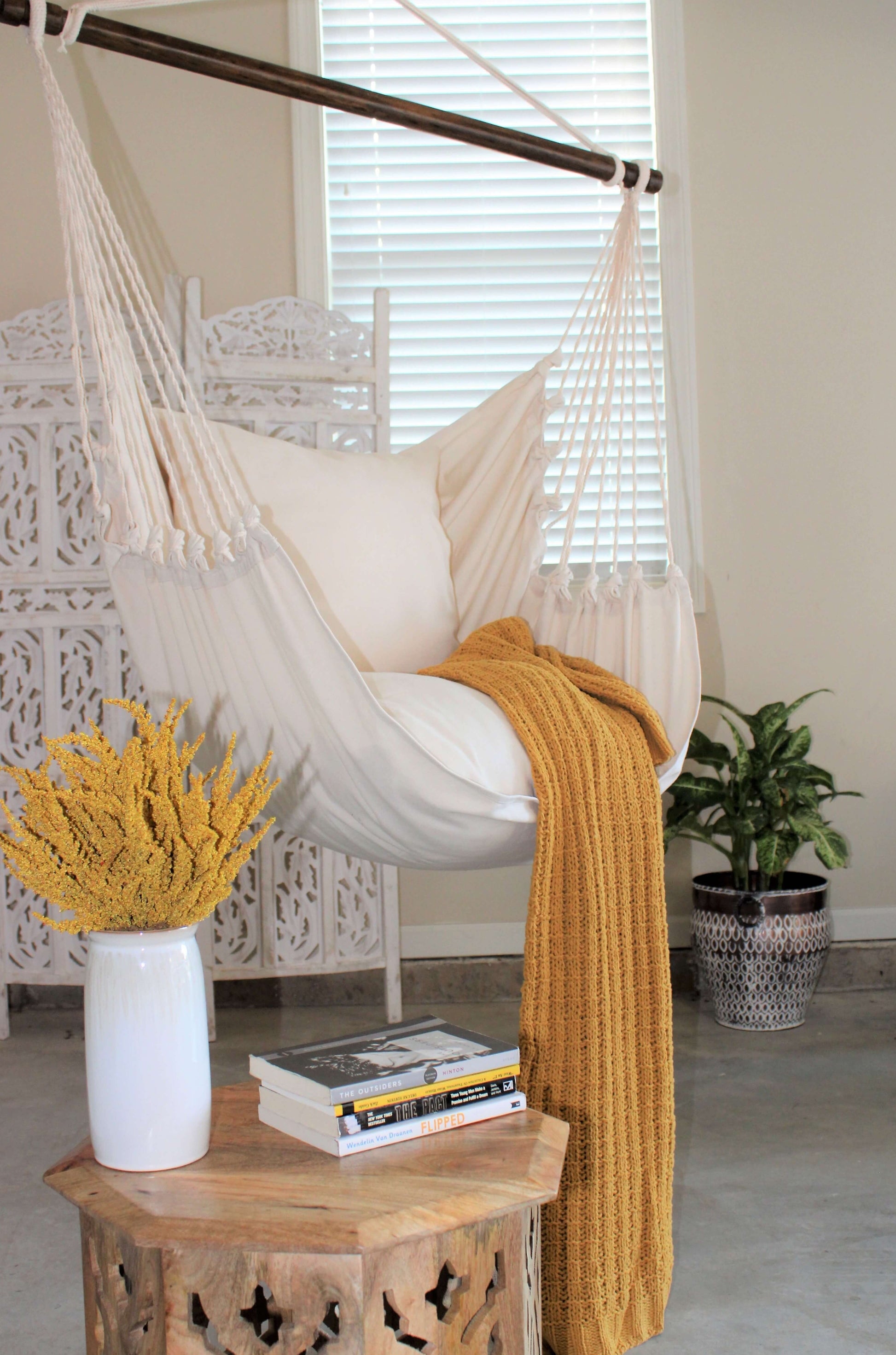 Hanging hammock chair swing with yellow blanket 