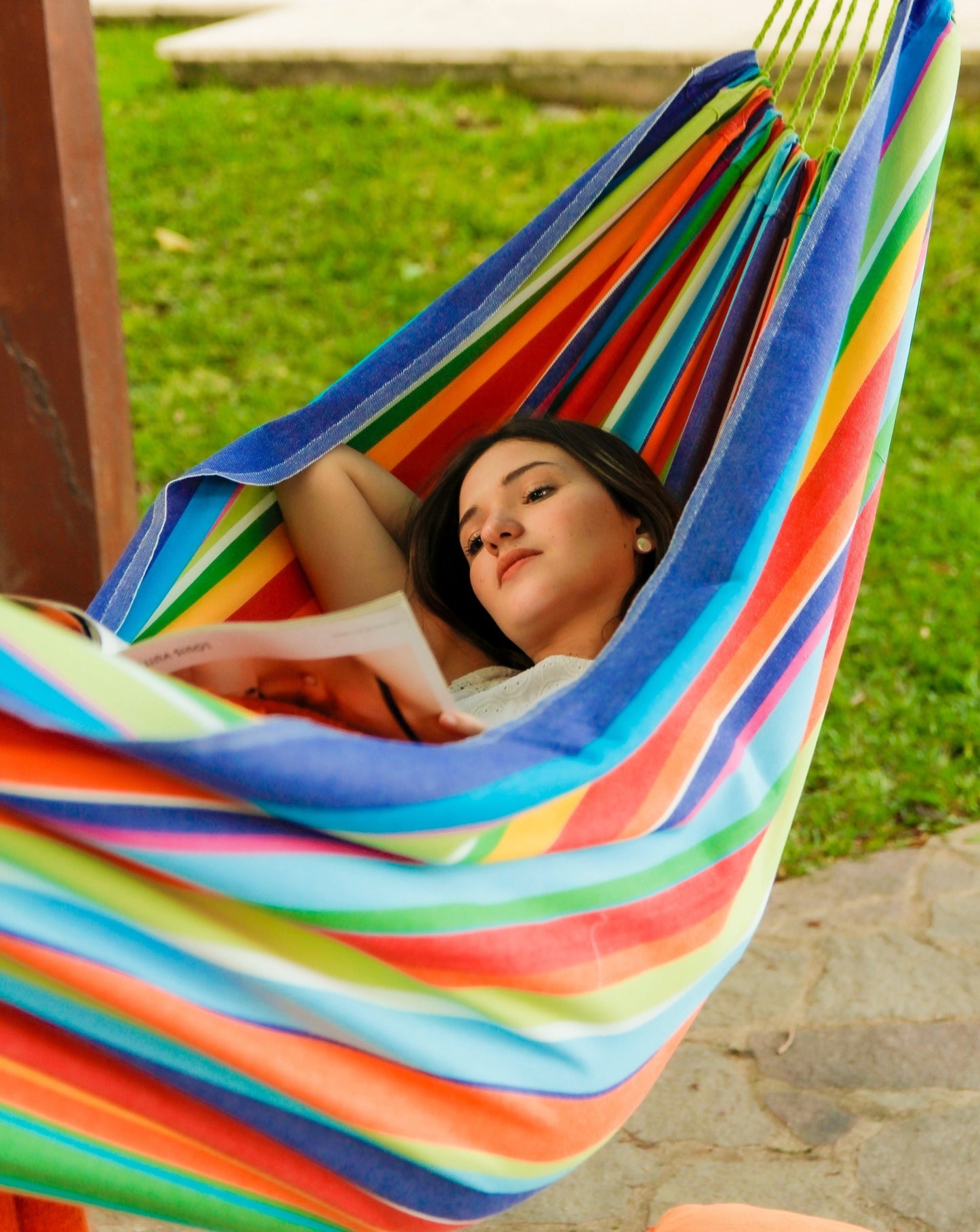 woman on a rainbow multi color hammock