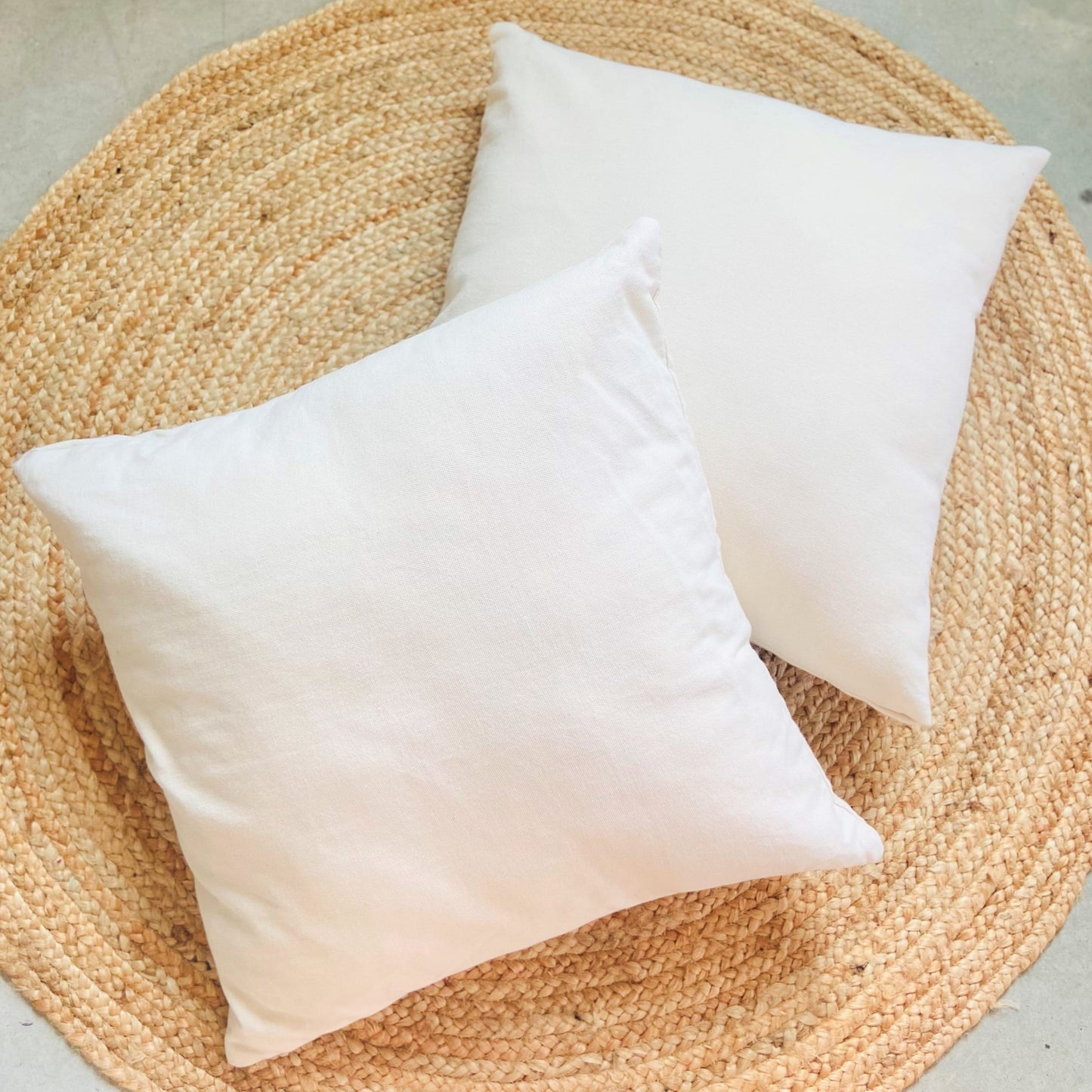 two hammock pillow cushions on a jute rug