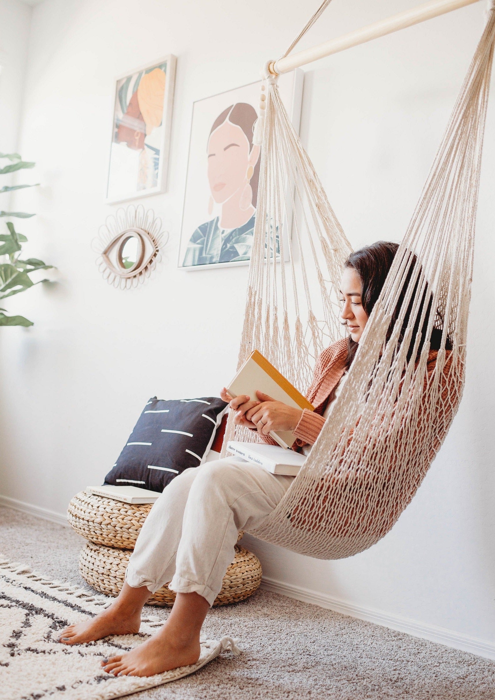  woman sitting on woven macrame hammock chair
